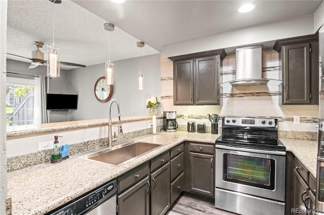 943 S Fairplay St, Aurora, CO 80012 - kitchen with stainless steel appliances, island range hood, a sink, decorative light fixtures, and light stone countertops