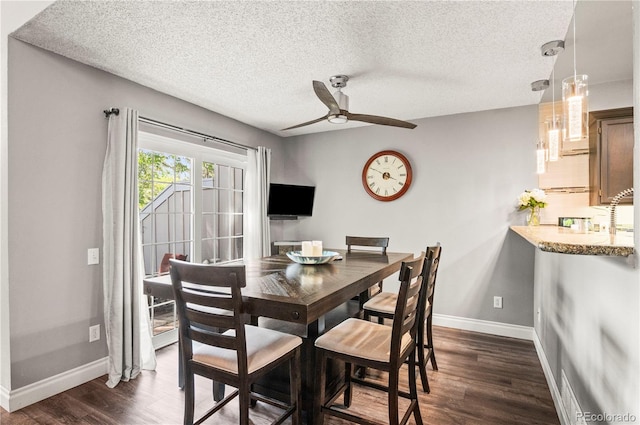 943 S Fairplay St, Aurora, CO 80012 - dining room with dark wood finished floors, baseboards, ceiling fan, and a textured ceiling