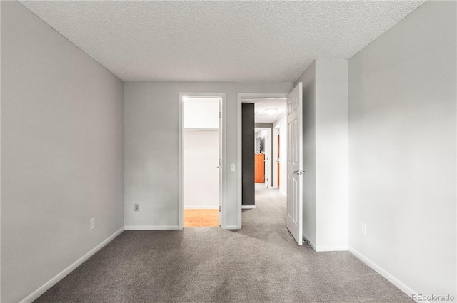 943 S Fairplay St, Aurora, CO 80012 - carpeted empty room featuring baseboards and a textured ceiling