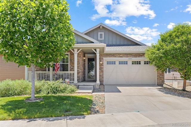 15895 Columbine St, Thornton, CO 80602 - craftsman-style house with board and batten siding, a porch, an attached garage, driveway, and stone siding