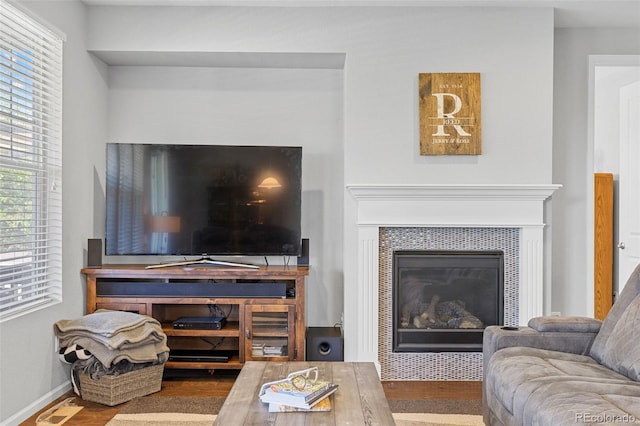 15895 Columbine St, Thornton, CO 80602 - living room with healthy amount of natural light, wood finished floors, and a tiled fireplace