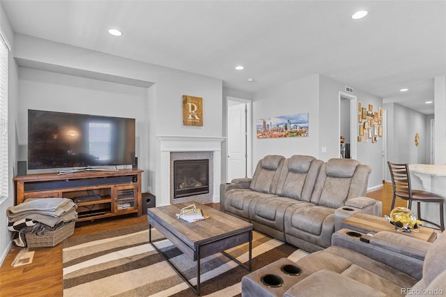 15895 Columbine St, Thornton, CO 80602 - living room featuring wood finished floors, recessed lighting, and a glass covered fireplace
