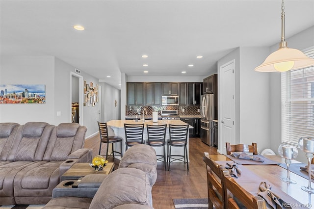 15895 Columbine St, Thornton, CO 80602 - living area featuring dark wood-type flooring and recessed lighting