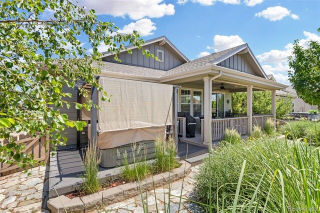 15895 Columbine St, Thornton, CO 80602 - view of property exterior featuring board and batten siding, a ceiling fan, a shingled roof, and a hot tub