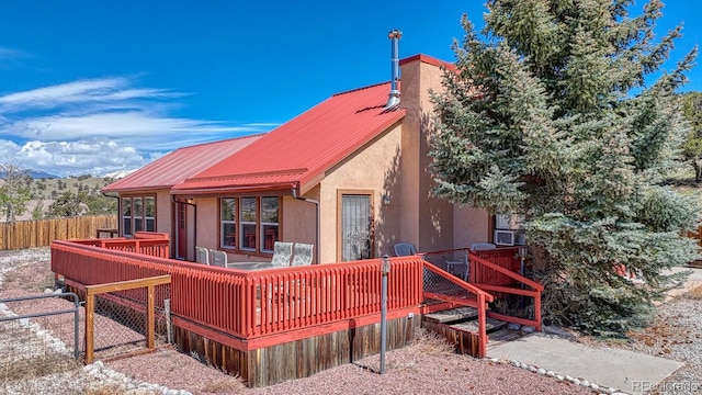 10199 W Cheyenne Cir, Salida, CO 81201 - rear view of property featuring a deck with mountain view, stucco siding, and metal roof