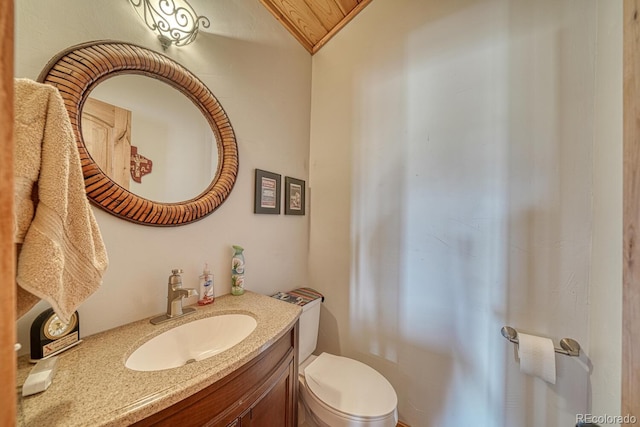 10199 W Cheyenne Cir, Salida, CO 81201 - bathroom featuring vanity, toilet, and lofted ceiling