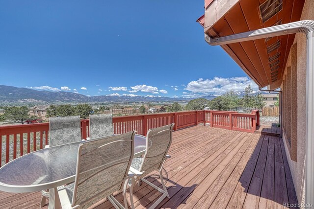10199 W Cheyenne Cir, Salida, CO 81201 - wooden deck featuring outdoor dining area and a mountain view