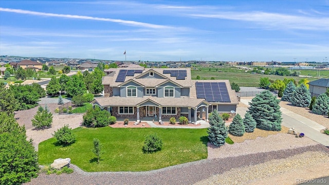 8655 E 130th Ave, Thornton, CO 80602 - view of front facade featuring a porch, solar panels, a front yard, and driveway
