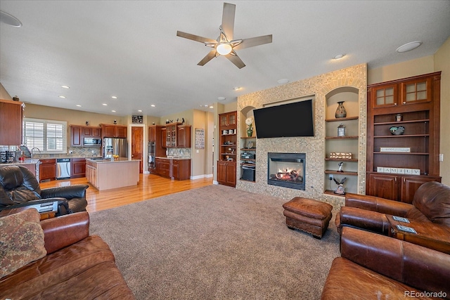8655 E 130th Ave, Thornton, CO 80602 - living room with ceiling fan, a fireplace, built in features, recessed lighting, and baseboards