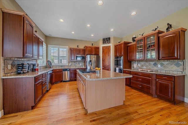 8655 E 130th Ave, Thornton, CO 80602 - kitchen with stainless steel appliances, tasteful backsplash, light wood-type flooring, a kitchen island, and recessed lighting