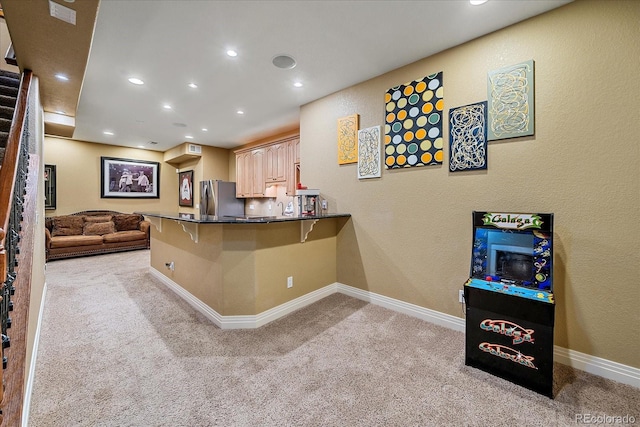 8655 E 130th Ave, Thornton, CO 80602 - kitchen with freestanding refrigerator, light colored carpet, a peninsula, a breakfast bar, and recessed lighting
