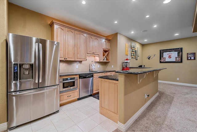 8655 E 130th Ave, Thornton, CO 80602 - kitchen featuring appliances with stainless steel finishes, recessed lighting, dark stone countertops, a kitchen island, and light brown cabinets