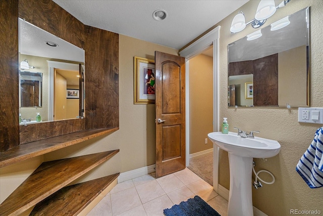8655 E 130th Ave, Thornton, CO 80602 - bathroom featuring tile patterned floors, baseboards, a sink, and a textured wall