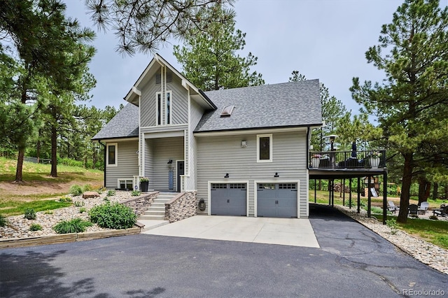 7312 Marshall Rd, Larkspur, CO 80118 - view of front of house with driveway, a shingled roof, an attached garage, and a deck