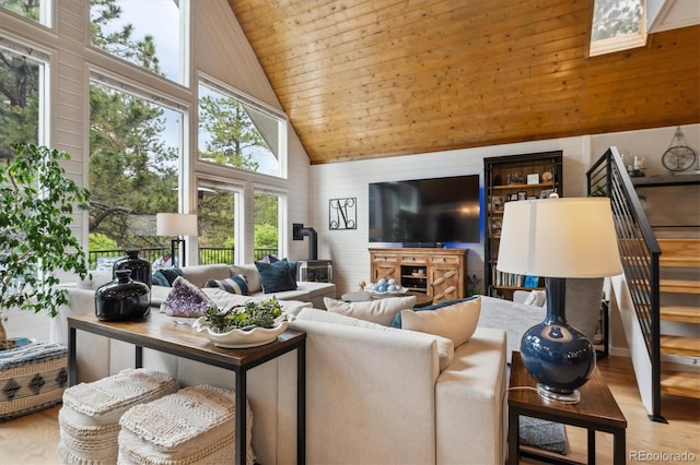 7312 Marshall Rd, Larkspur, CO 80118 - living area featuring high vaulted ceiling, wood ceiling, a wood stove, stairs, and wood finished floors