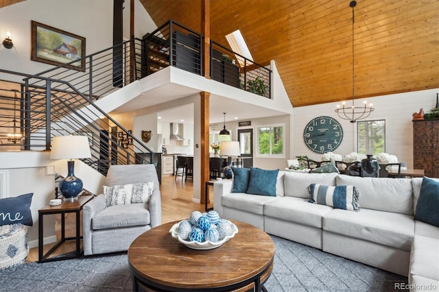7312 Marshall Rd, Larkspur, CO 80118 - living area featuring high vaulted ceiling, stairway, a chandelier, wood ceiling, and wood finished floors