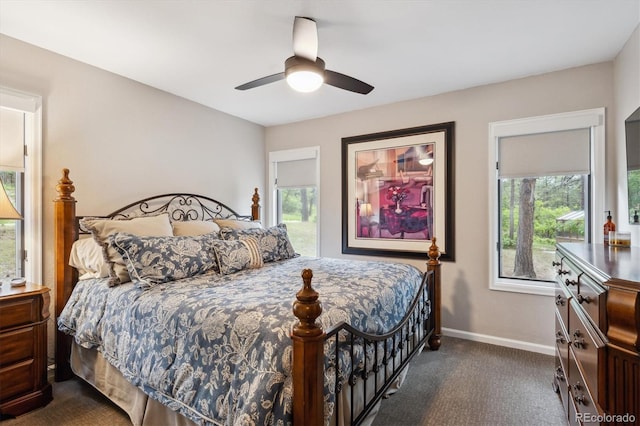 7312 Marshall Rd, Larkspur, CO 80118 - bedroom with dark carpet, multiple windows, and ceiling fan