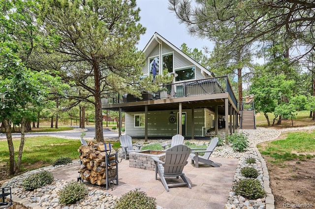 7312 Marshall Rd, Larkspur, CO 80118 - rear view of house with an outdoor fire pit, stairs, a wooden deck, and a patio