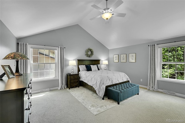 bedroom featuring light carpet, lofted ceiling, baseboards, and ceiling fan