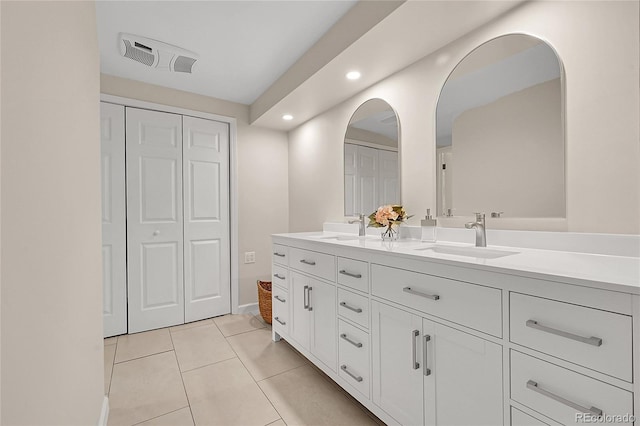 full bath with recessed lighting, tile patterned floors, double vanity, a closet, and baseboards