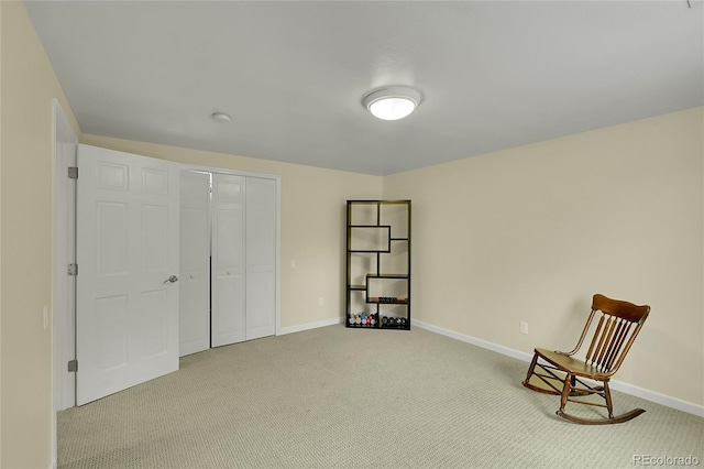 unfurnished room featuring light carpet and baseboards