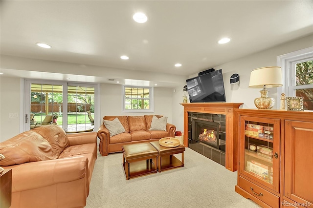 carpeted living room with recessed lighting, a fireplace, and plenty of natural light
