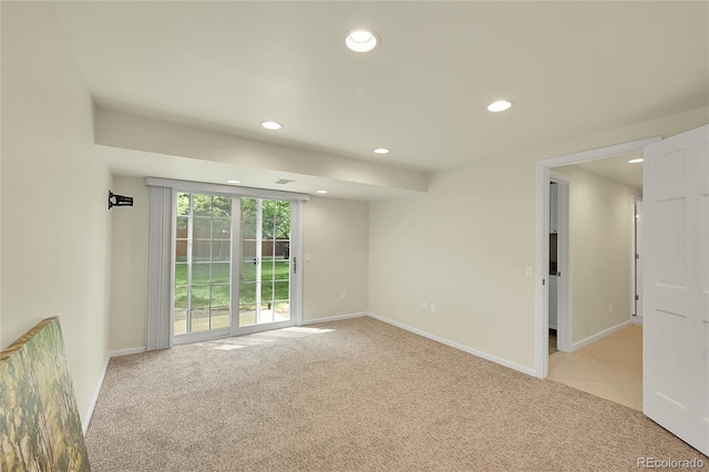 empty room with light carpet, recessed lighting, and baseboards