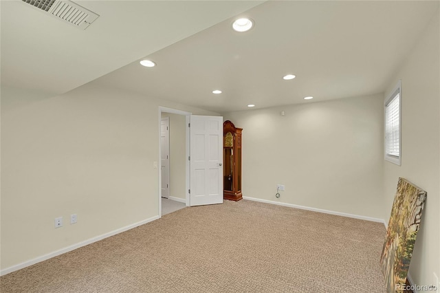 unfurnished room featuring recessed lighting, light carpet, and baseboards