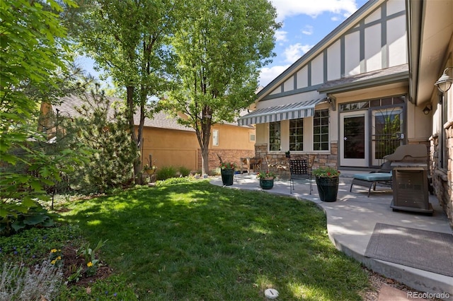 652 Ulster Way, Denver, CO 80230 - view of green lawn featuring a patio area