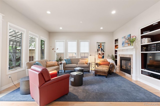 652 Ulster Way, Denver, CO 80230 - living area featuring a tiled fireplace, recessed lighting, baseboards, built in shelves, and wood finished floors
