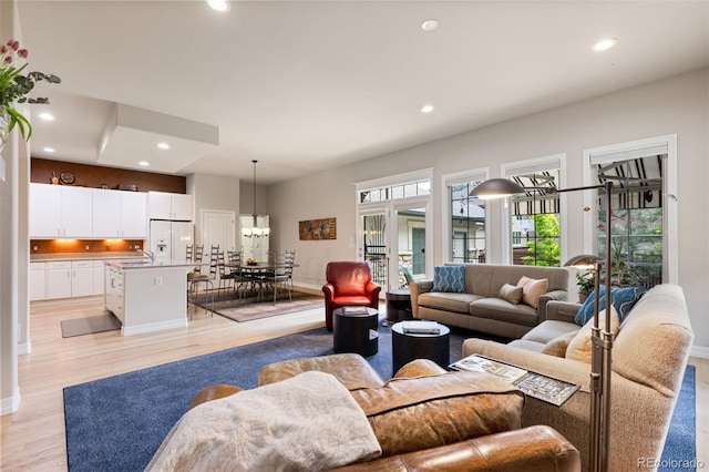 652 Ulster Way, Denver, CO 80230 - living area with recessed lighting, light wood-type flooring, and baseboards