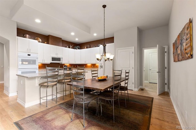 652 Ulster Way, Denver, CO 80230 - dining space with light wood finished floors, baseboards, recessed lighting, and a chandelier