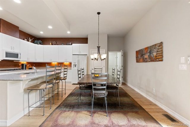 652 Ulster Way, Denver, CO 80230 - dining space featuring recessed lighting, light wood-style flooring, baseboards, and a chandelier