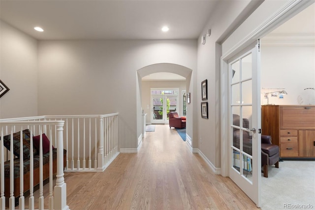 652 Ulster Way, Denver, CO 80230 - corridor featuring arched walkways, light wood-type flooring, recessed lighting, and french doors