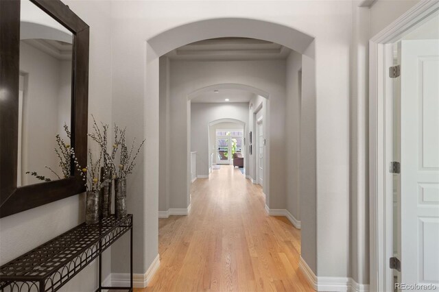 652 Ulster Way, Denver, CO 80230 - hall featuring arched walkways, light wood finished floors, and baseboards