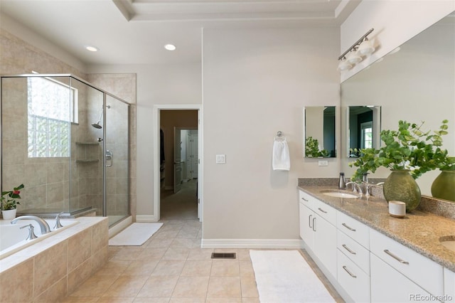 652 Ulster Way, Denver, CO 80230 - bathroom featuring a bath, double vanity, tile patterned floors, a stall shower, and baseboards