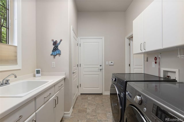 652 Ulster Way, Denver, CO 80230 - washroom with washer and dryer, baseboards, cabinet space, and stone finish floors