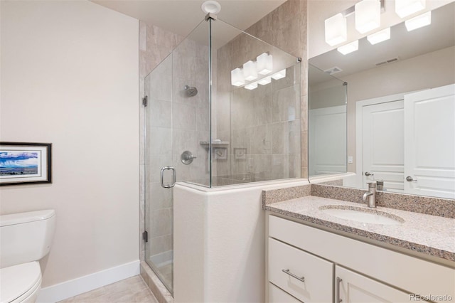 652 Ulster Way, Denver, CO 80230 - bathroom featuring toilet, vanity, baseboards, and a stall shower