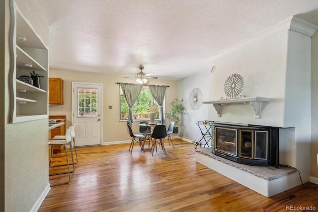 3871 W Saratoga Ave, Littleton, CO 80123 - dining area featuring light wood-type flooring, a textured ceiling, and a ceiling fan