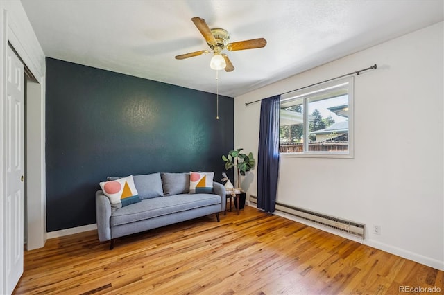3871 W Saratoga Ave, Littleton, CO 80123 - sitting room featuring a baseboard heating unit, light wood-style flooring, and a ceiling fan