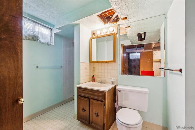 3871 W Saratoga Ave, Littleton, CO 80123 - bathroom with a textured ceiling, tile patterned floors, vanity, and backsplash