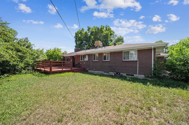 3871 W Saratoga Ave, Littleton, CO 80123 - rear view of house with a deck, brick siding, and a lawn