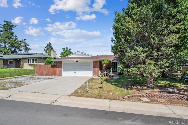 3871 W Saratoga Ave, Littleton, CO 80123 - ranch-style house featuring brick siding, driveway, and a garage