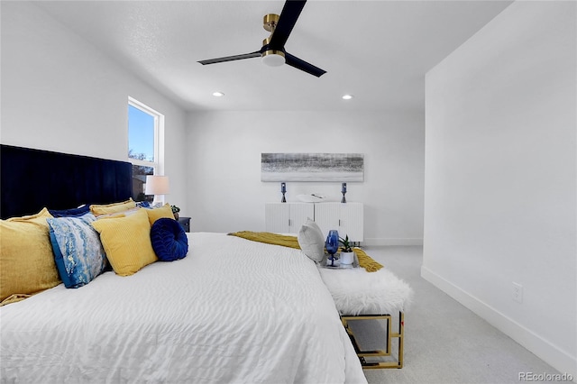 bedroom featuring light carpet, radiator, and ceiling fan