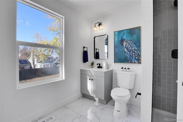 bathroom featuring vanity, toilet, and walk in shower