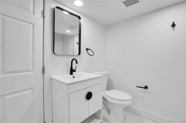 bathroom with tile patterned flooring, vanity, and toilet