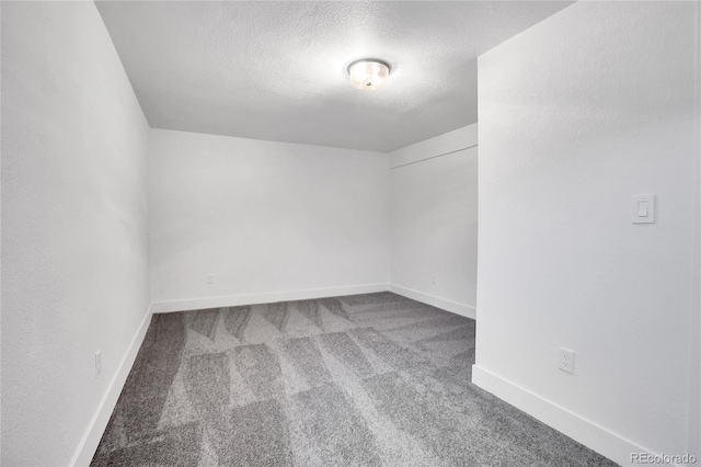 carpeted spare room featuring a textured ceiling