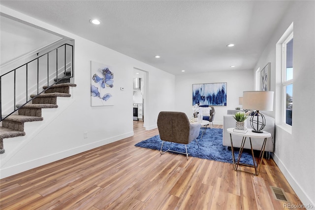 living room featuring hardwood / wood-style floors and a textured ceiling