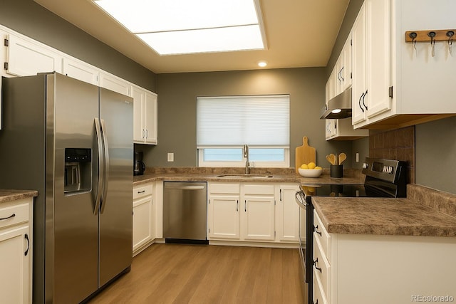 5555 E Briarwood Ave Unit 706, Centennial, CO 80122 - kitchen featuring stainless steel appliances, a sink, light wood-type flooring, white cabinets, and range hood