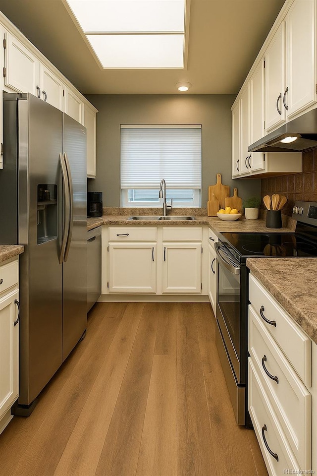 5555 E Briarwood Ave Unit 706, Centennial, CO 80122 - kitchen with appliances with stainless steel finishes, under cabinet range hood, a sink, white cabinets, and recessed lighting